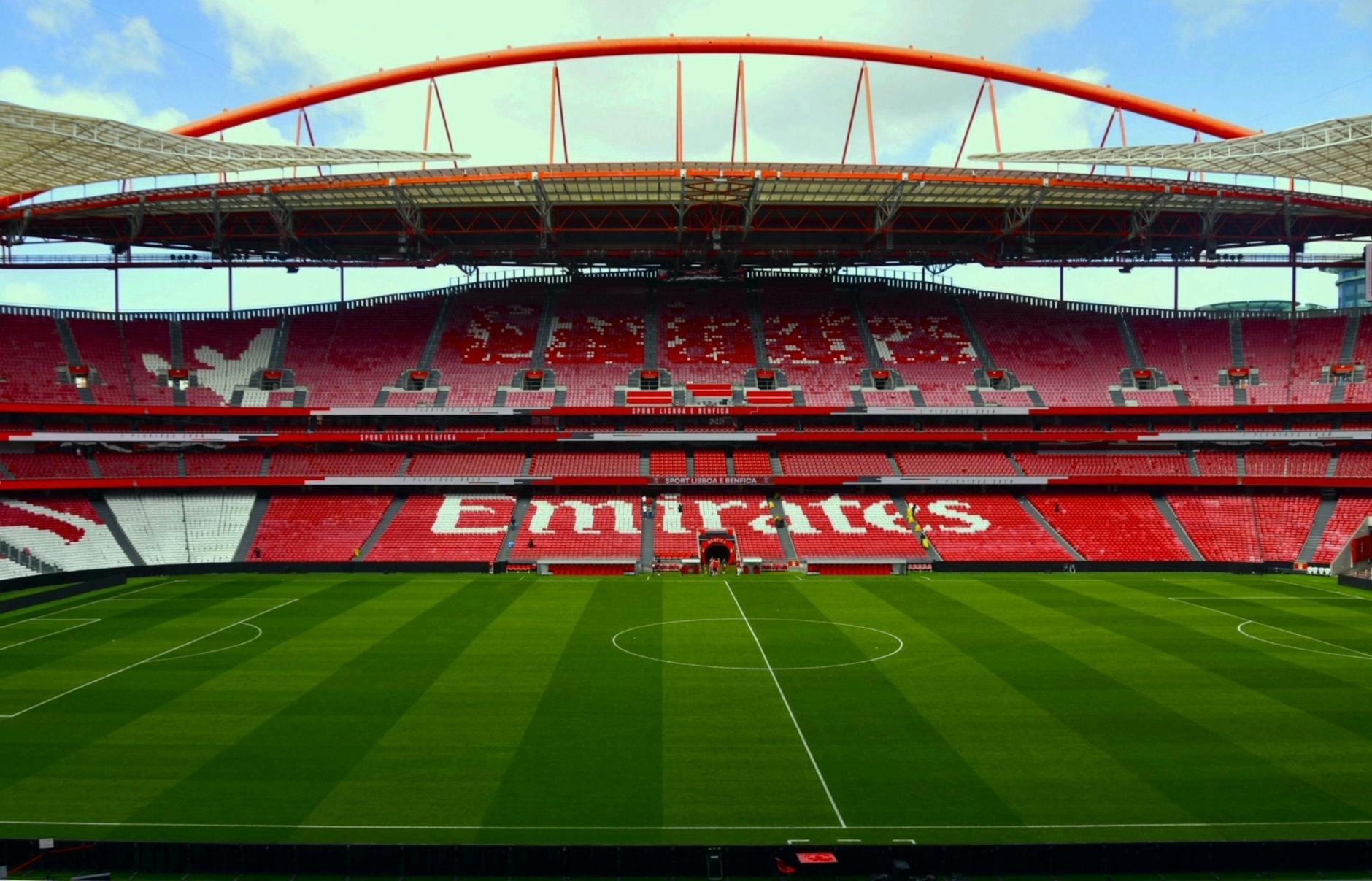 Wide-angle view of Estádio da Luz, home of Benfica, showcasing its vibrant seating and field.