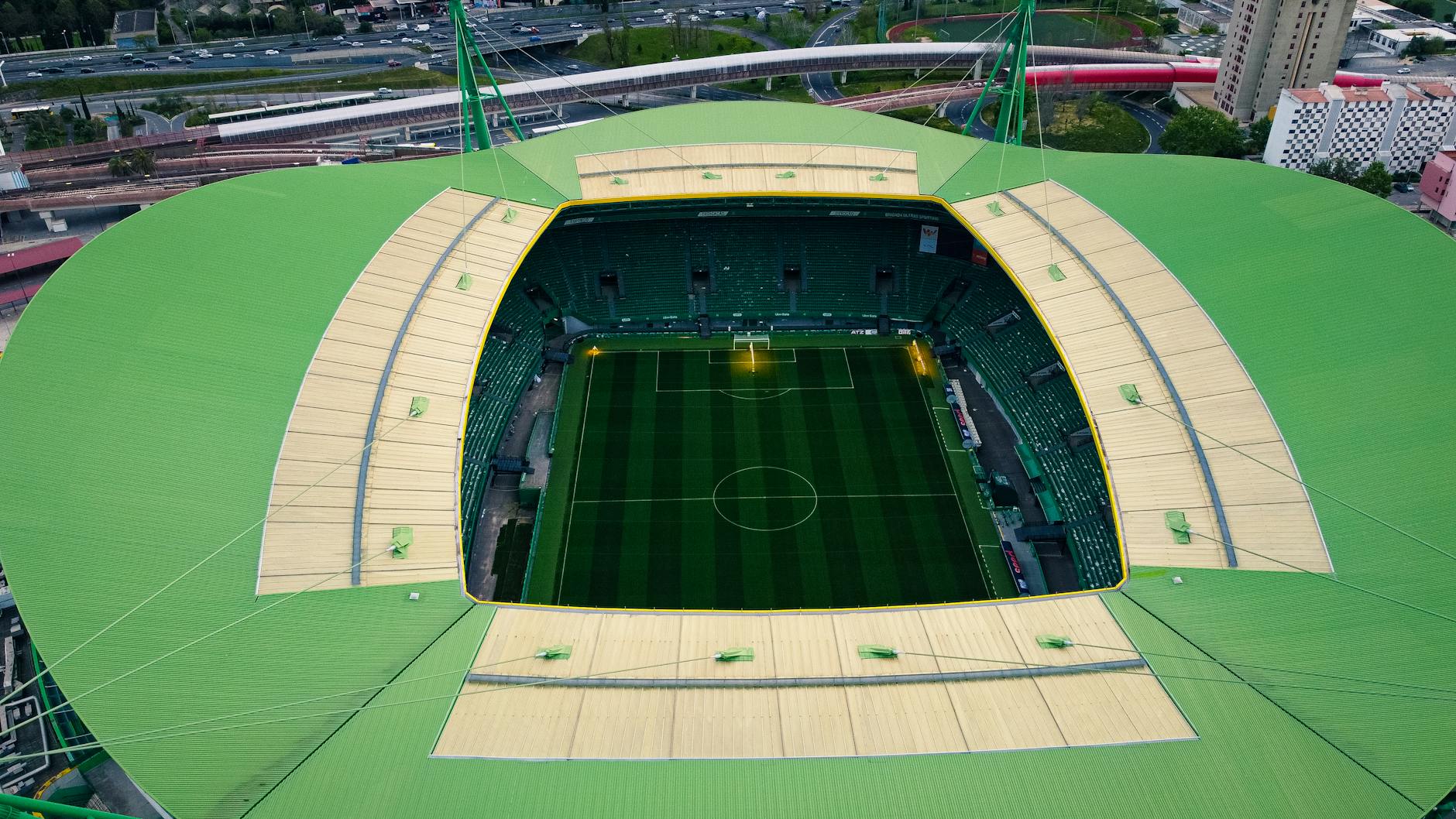 A stunning aerial shot of Estádio José Alvalade in Lisbon, showcasing its unique architecture and lush field.