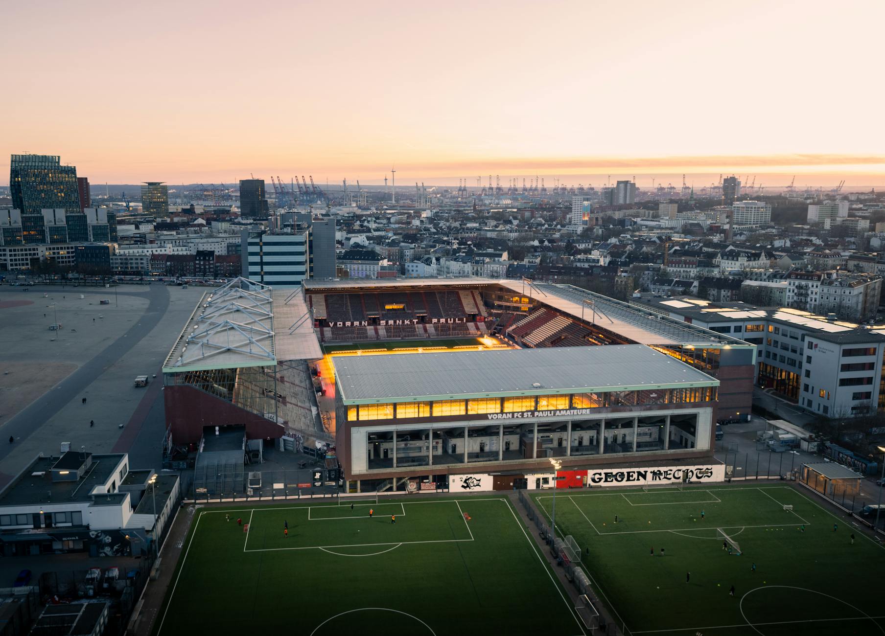 A stunning aerial shot of FC St. Pauli Stadium in Hamburg during a beautiful sunset.